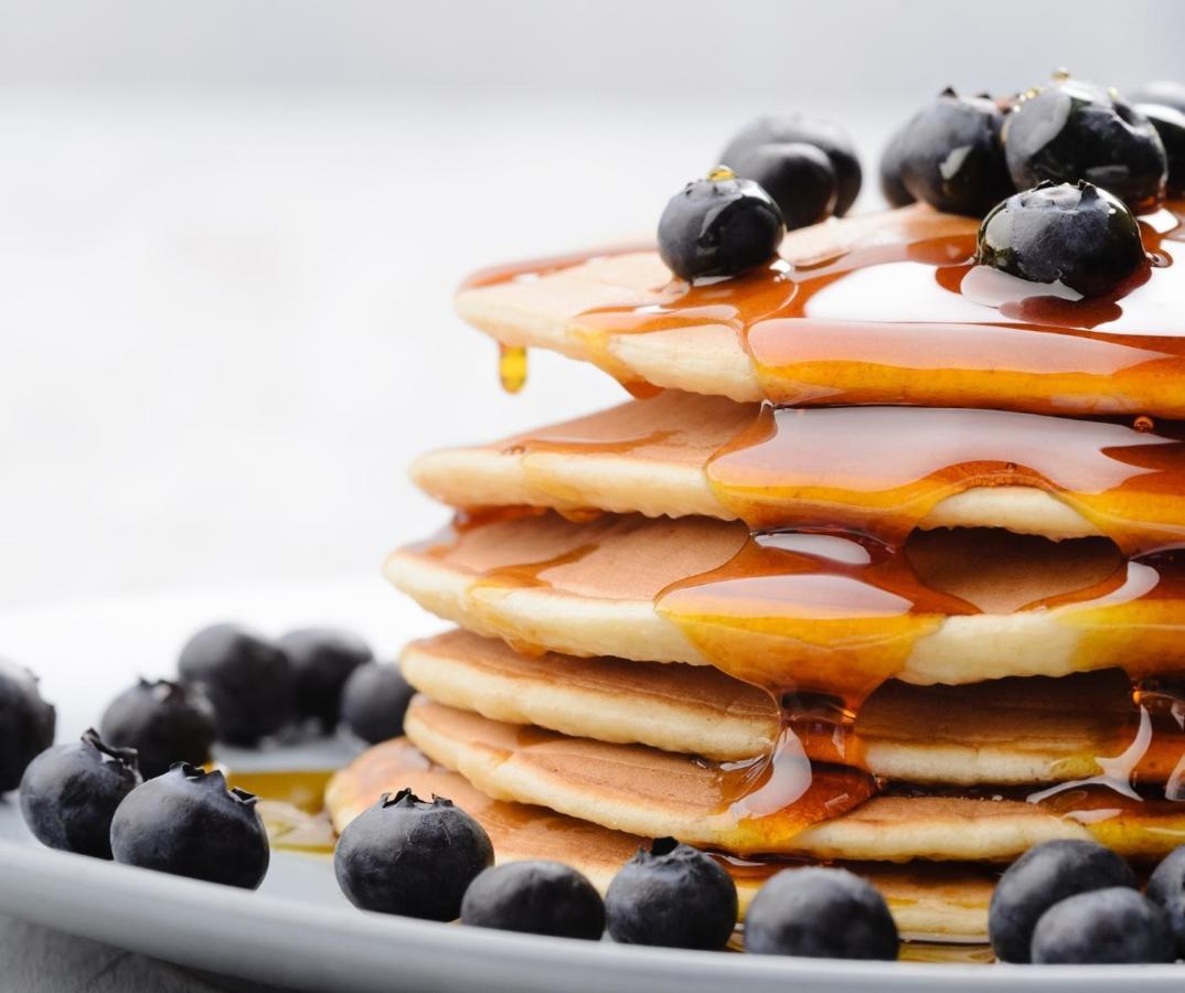 The Sense Experience Resort Follonica Zewnętrze zdjęcie A stack of pancakes with maple syrup and blueberries
